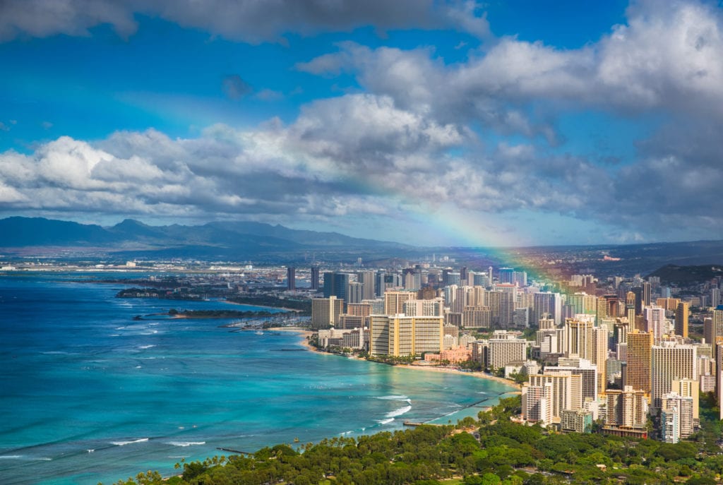 Stunning view of the beachfront buildings in Honolul spotted with a rainbow